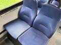 Two blue cloth seats arranged side by side in a Chevrolet Express van interior