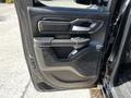 The interior door panel of a 2019 RAM 1500 featuring a handle a control switch and a speaker grille