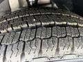 Close-up of a tire tread on a 2009 Dodge Grand Caravan showing intricate patterns and grooves designed for traction