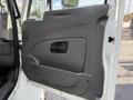 The interior door panel of a 2012 International 4300 featuring a gray finish with a handle and a speaker cutout
