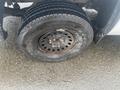 A 2015 GMC Sierra 1500 with a flat tire showing the wheel and tire tread