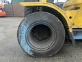 Close-up of a large black tire on a yellow Hyster 120 forklift showcasing its textured surface and robust design