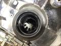 A close-up view of the oil filter housing of a 2022 Harley-Davidson FLHT showing a black circular opening with internal ridges and grooves