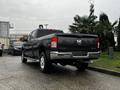 A black 2020 RAM 3500 pickup truck is parked with its rear facing the viewer displaying chrome accents and a tow hitch