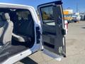 A 2019 Ford F-150 with an open front door showing a spacious interior and gray cloth seats