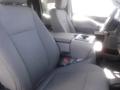 The interior of a 2018 Ford F-350 SD featuring two front seats with fabric upholstery and a center console with storage space and cup holder