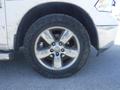 A close-up of a silver alloy wheel with five spokes mounted on a rugged tire, part of a 2019 RAM 1500 Classic Eco Diesel