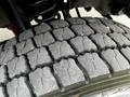 Close-up view of a tire on a 2016 Ford F-550 showing a rugged tread pattern designed for traction and durability