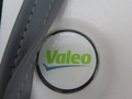 2020 Chevrolet Express van with a close-up view of a circular Valeo logo on a white surface