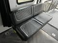 A sleek black leather bench seat with diamond stitching  designed for a recreational vehicle