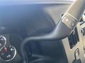 Close-up of the steering wheel of a 2013 Chevrolet Express showcasing control buttons and instrument dials