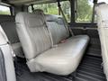 Interior view of the rear bench seat in a 2021 Chevrolet Express with gray upholstery and seat belts