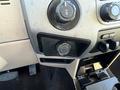 Interior dashboard of a 2014 Ford F-350 SD with dials and control knobs visible along with a storage compartment below