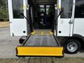 A 2020 Chevrolet Express with a lowered ramp for wheelchair access positioned at the rear entrance
