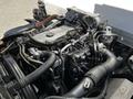 A close-up view of the engine of a 2007 GMC W3500 showing complex pipelines wires and components assembled in a compact layout