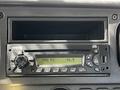A Sirius radio unit installed in a 2012 Freightliner M2 106 with a digital display showing FM station 92.5 and various control buttons and knobs