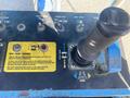 Control panel of a 1997 Genie S-65 4X4 showing joystick for steering and drive functions with labeled buttons and indicators
