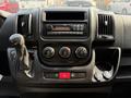 Dashboard of a 2017 RAM Promaster featuring air conditioning controls a CD player and various buttons and knobs for vehicle operation