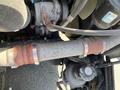 A close-up view of the engine components of a 2022 Freightliner Cascadia focusing on the silver pipe with red clamps and visible machinery attached to it