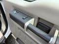 A close-up view of the door handle and control panel of a 2008 Ford F-550 indicating window and lock controls
