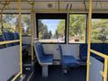 Interior of a 2016 Grande West Vicinity bus showing empty seats and yellow grab rails