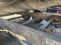 Close-up view of the undercarriage of a 2024 Southland 18 Foot Dump Trailer showing the wheels axles and frame components