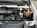 Image of the engine compartment of a 2016 Ford Econoline showing components like the air intake, coolant reservoir and various hoses and wires