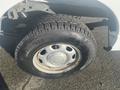 A close-up of a tire mounted on a silver wheel of a 2013 Ford F-150 showing rugged tread and a slight wear on the wheel rim