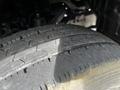 Close-up of a worn tire from a 2004 Toyota Toyoace showing visible tread wear and cracks