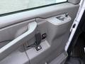 Interior door panel of a 2016 GMC Savana featuring a door handle power window controls and a speaker grille