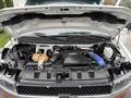 A 2013 Chevrolet Express with its hood open revealing the engine compartment including the engine, air intake, and various components