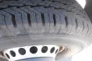 Close-up of a tire mounted on a 2012 Mercedes-Benz Sprinter showing a detailed tread pattern and metal rim
