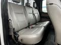 Interior rear seating of a 2019 Ford F-550 with grey leather upholstery and a flat floor design