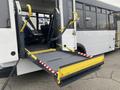 A 2017 Chevrolet Express with a wheelchair ramp extended on the rear entrance