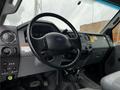 Interior view of a 2013 Ford F-650 showing the steering wheel dashboard and control panel with various buttons and switches