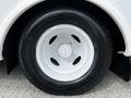 Close-up of a white wheel and tire from a 2016 Ford Econoline featuring a steel rim and a Michelin tire with detailed tread pattern