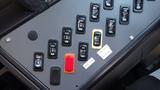 Control panel of a 2014 Freightliner Thomas Bus featuring various buttons and switches labeled for different functions