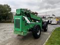 A green 2014 JLG 10054 telehandler with large black tires and a boom extending from the rear