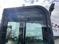 A 2024 AGT Industrial Green QH13R Mini Excavator cabin featuring large windows and a roof-mounted light