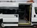 A white 2016 RAM Promaster van with an open side door and wheelchair accessibility features visible inside