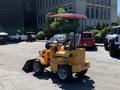 A yellow 2024 Traner TR 45 tractor with a red canopy and front loader attachment parked in a lot