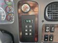 Dashboard controls of a 2016 Freightliner M2 106 featuring an Allison transmission selector with buttons and an analog gauge displaying temperature and pressure indicators