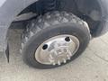 Close-up of a tire on a 2017 Ford F-550 showcasing a chrome wheel rim and textured tread pattern