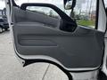 The image shows the interior door panel of a 2018 Hino 195 featuring a gray design with various controls and a handle for opening the door