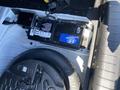 A 2017 Genesis G80 battery placed in the trunk compartment alongside a spare tire and tools