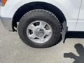 A close-up view of a silver alloy wheel on a 2012 Ford F-150 featuring a black tire branded with Toyo and visible tread pattern