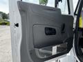 A gray door panel of a 2019 International 4300 with a handle and a storage compartment at the bottom