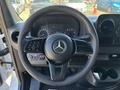 A steering wheel of a 2019 Mercedes-Benz Sprinter with a central Mercedes-Benz logo and various control buttons on the left side