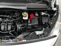 Engine compartment of a 2019 Ford Transit Connect showcasing various components including the battery air intake and fluid reservoirs