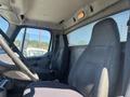 Interior view of a 2007 Freightliner M2 106 showing two cloth seats and a dashboard with controls and a steering wheel